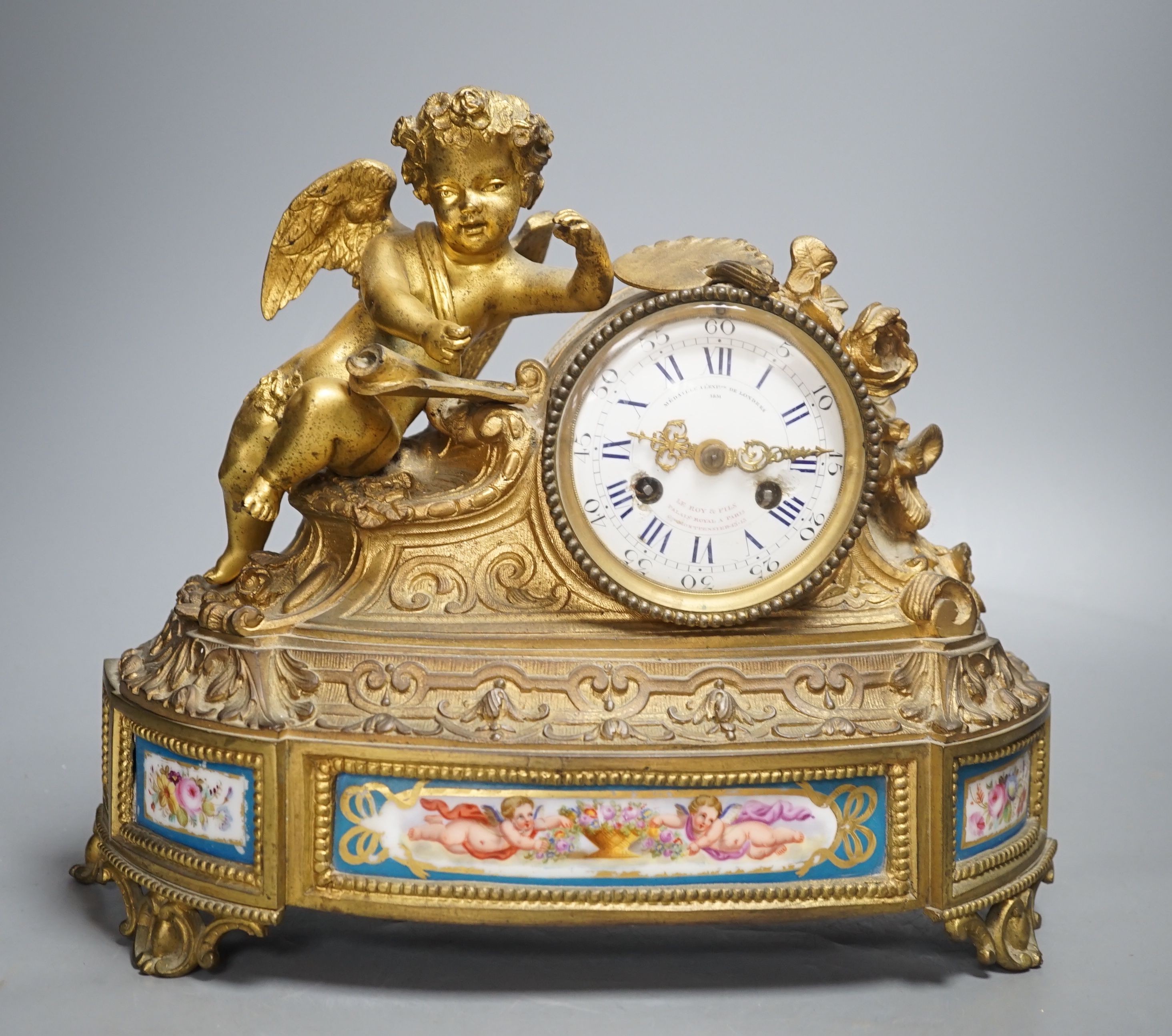 A French ormolu and Sevres style porcelain mounted putti mantel clock by Le Roy et Fils, Palais Royale, Paris, 26 cms high.